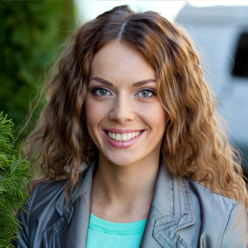Profile of a beutiful 20-something white woman with long curl brown hair.